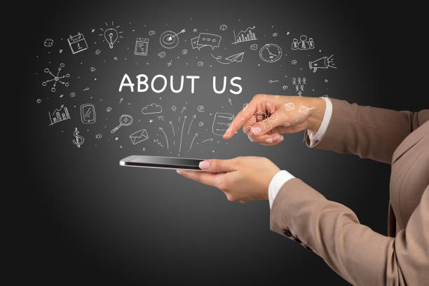 Close-up of a touchscreen with ABOUT US inscription, social media concept